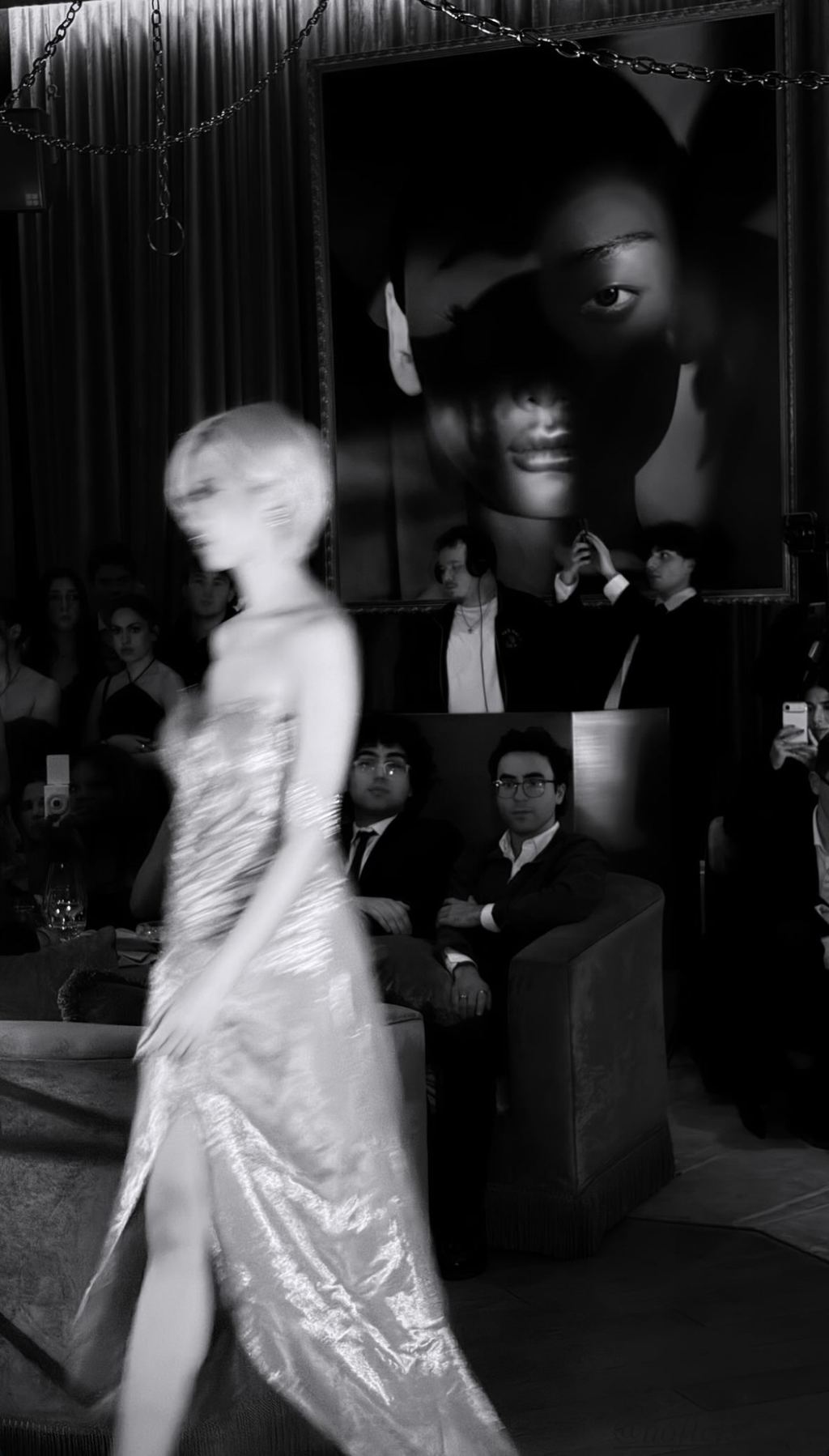 Blurred motion of a model walking a runway at a styled fashion event