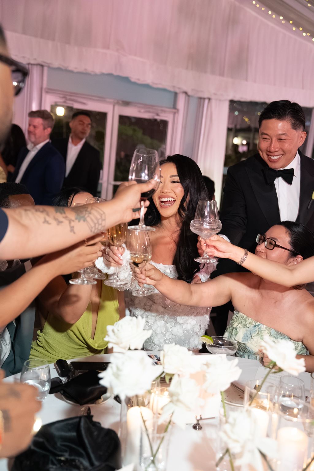 Wedding guests clinking glasses in a joyful toast
